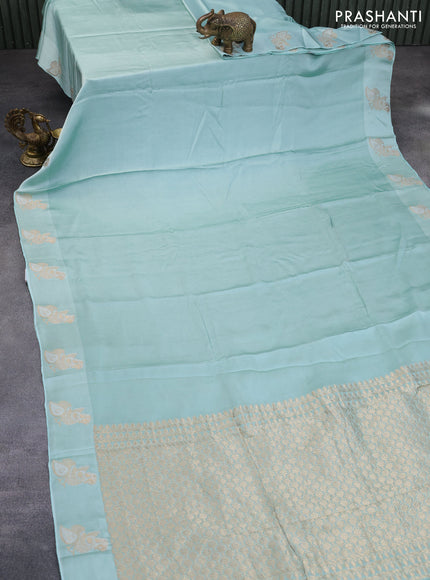 Mushru silk saree pastel blue with plain body and annam zari woven butta border