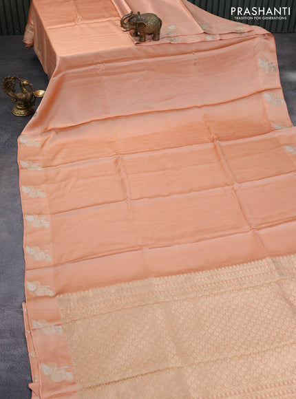 Mushru silk saree pale orange with plain body and annam zari woven butta border