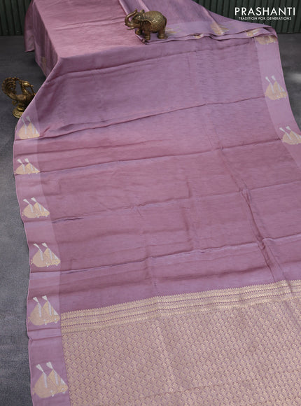 Mushru silk saree pastel purple with allover self emboss and zari woven butta border