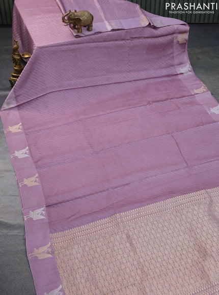 Mushru silk saree pastel purple with allover self emboss and zari woven butta border