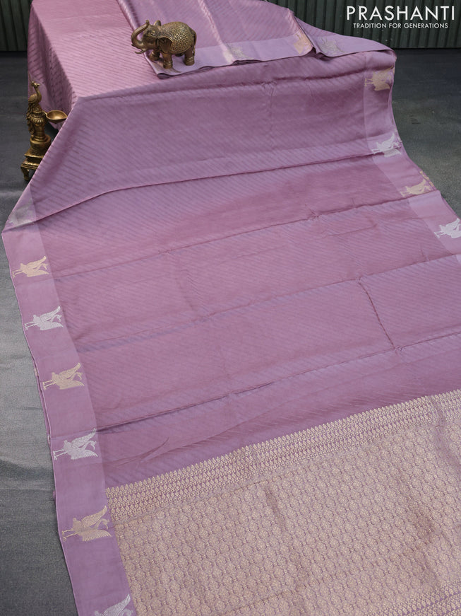 Mushru silk saree pastel purple with allover self emboss and zari woven butta border