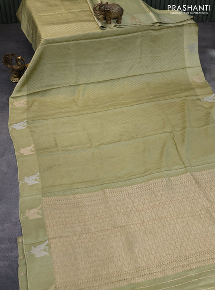 Mushru silk saree pastel green with allover self emboss and zari woven butta border