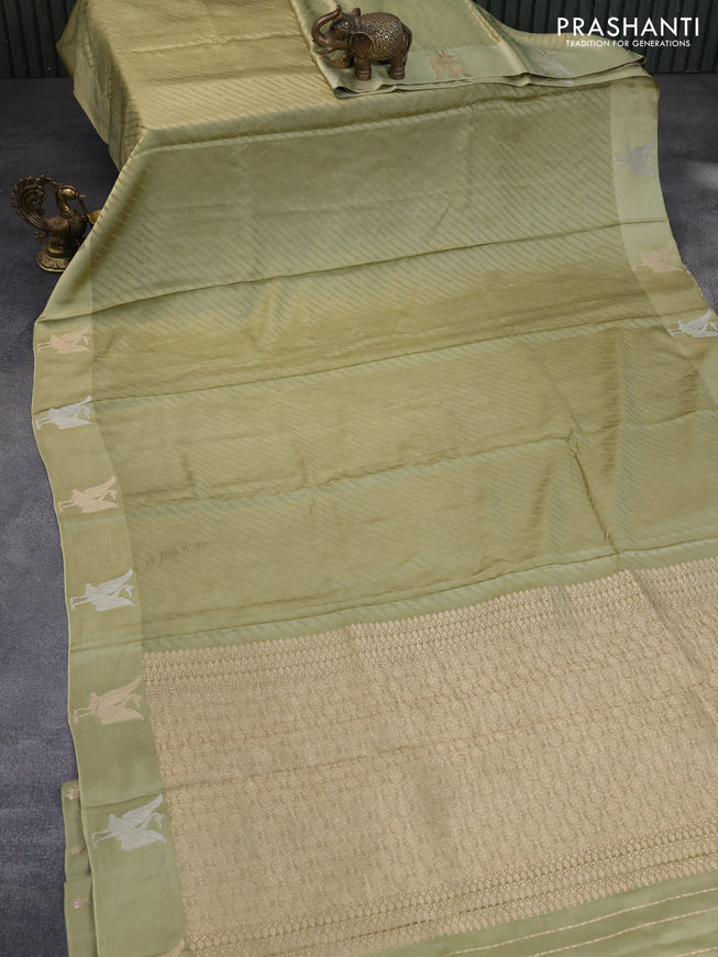 Mushru silk saree pastel green with allover self emboss and zari woven butta border