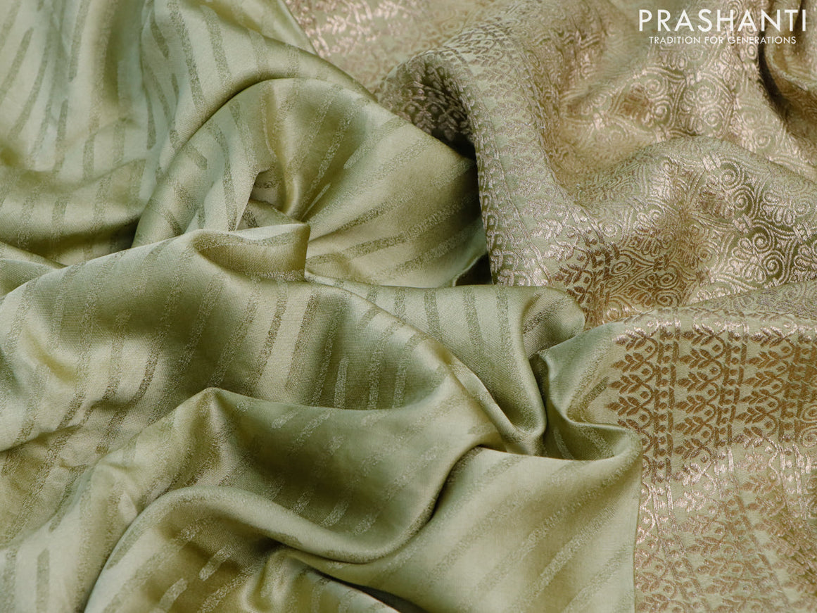 Mushru silk saree pastel green with allover self emboss and zari woven butta border