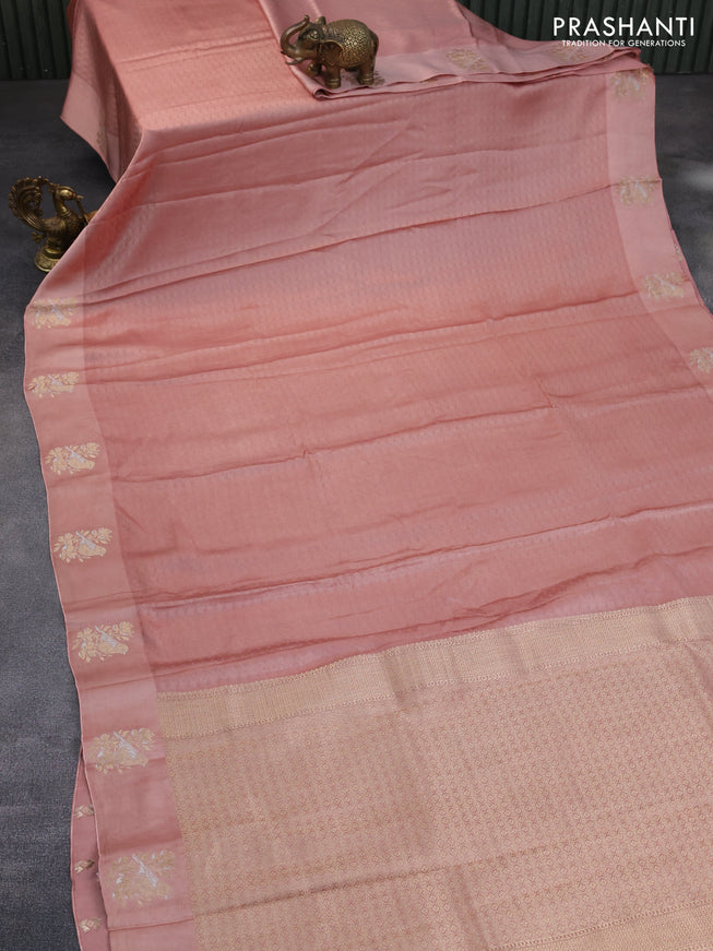 Mushru silk saree pastel peach with allover self emboss and zari woven butta border