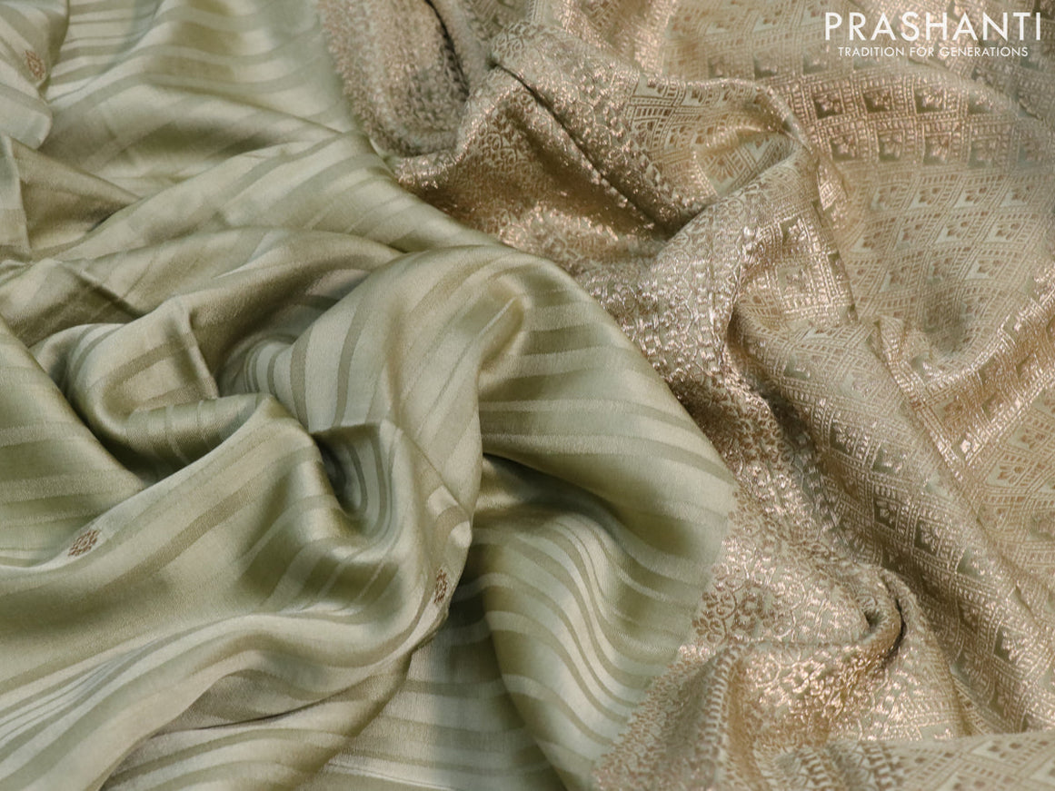 Mushru silk saree pastel green with allover self emboss & zari buttas and zari woven butta border