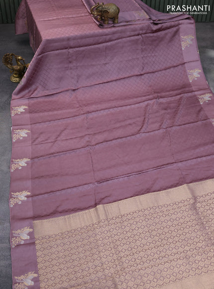 Mushru silk saree pastel purple with allover self emboss and zari woven butta border