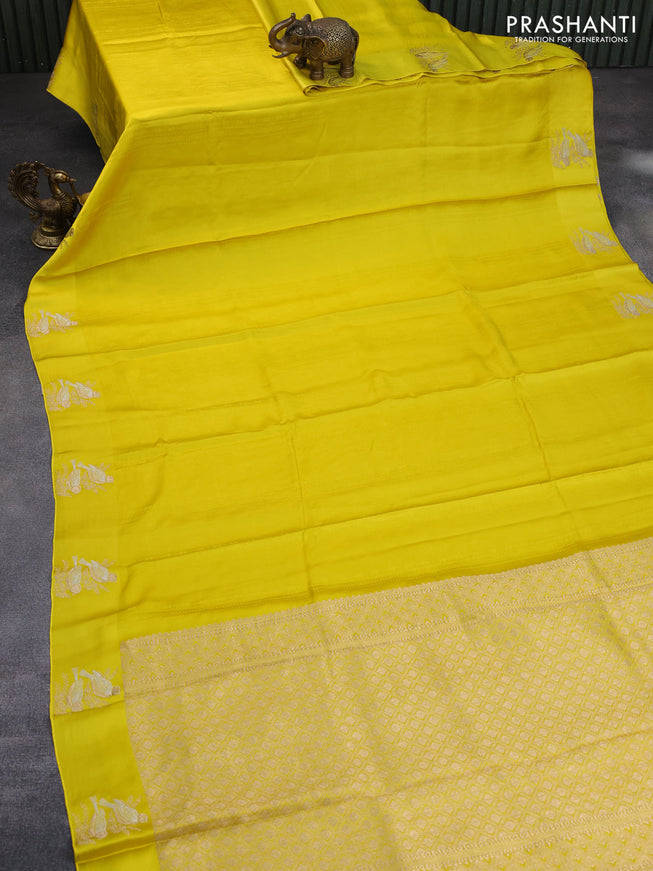 Mushru silk saree lime yellow with allover self emboss and zari woven butta border