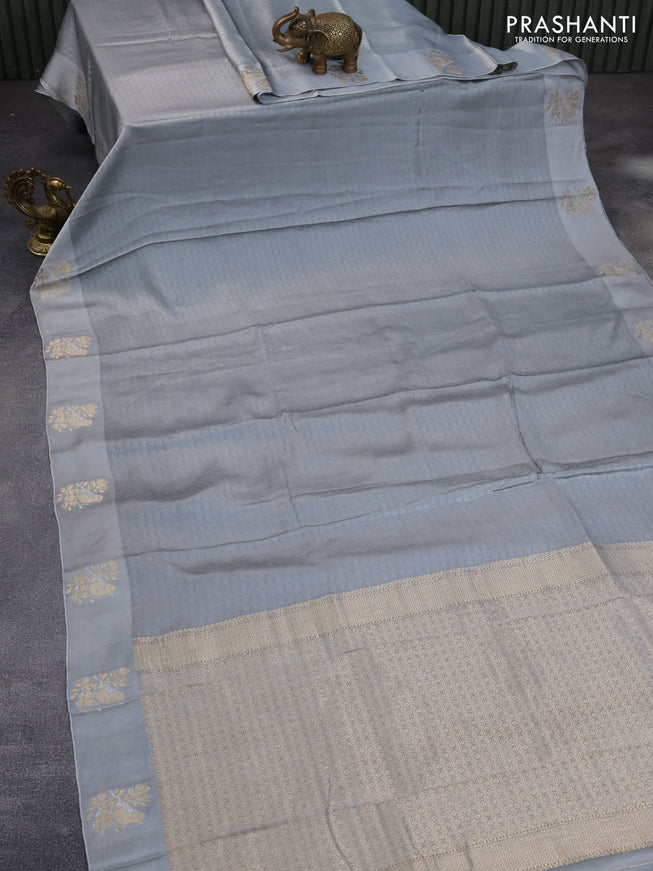 Mushru silk saree grey with allover self emboss and zari woven butta border