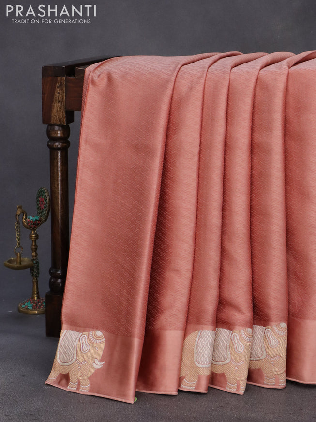 Mushru silk saree pastel peach with allover self emboss and zari woven elephant butta border