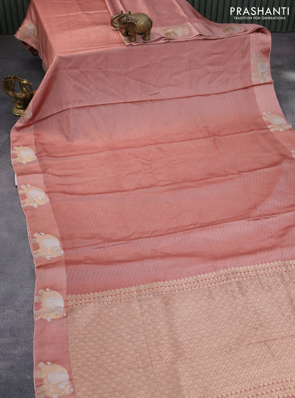 Mushru silk saree pastel peach with allover self emboss and zari woven elephant butta border