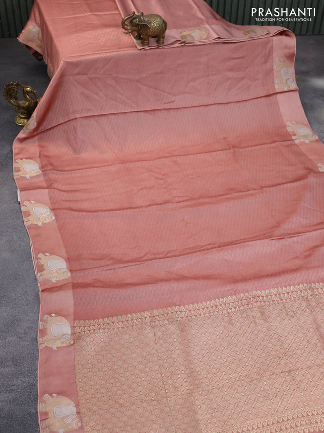 Mushru silk saree pastel peach with allover self emboss and zari woven elephant butta border