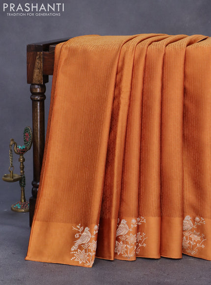 Mushru silk saree rust shade with allover self emboss and zari woven butta border