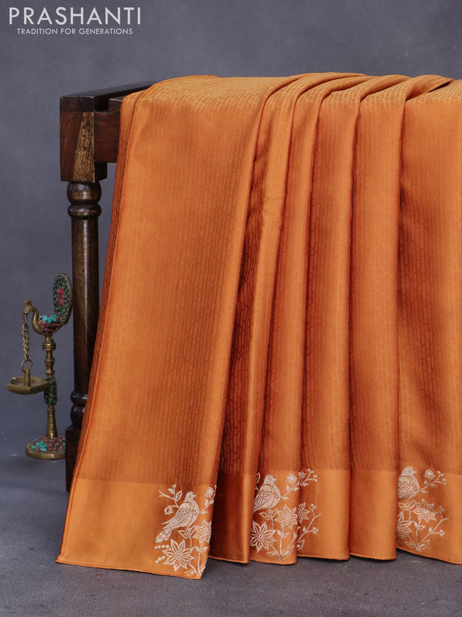 Mushru silk saree rust shade with allover self emboss and zari woven butta border