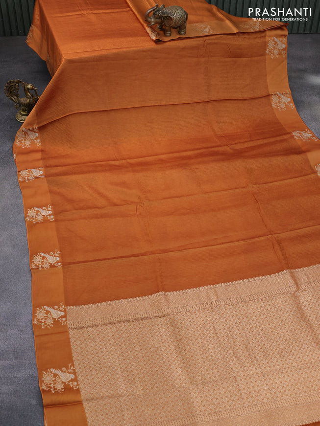 Mushru silk saree rust shade with allover self emboss and zari woven butta border