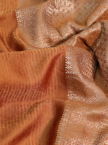 Mushru silk saree rust shade with allover self emboss and zari woven butta border