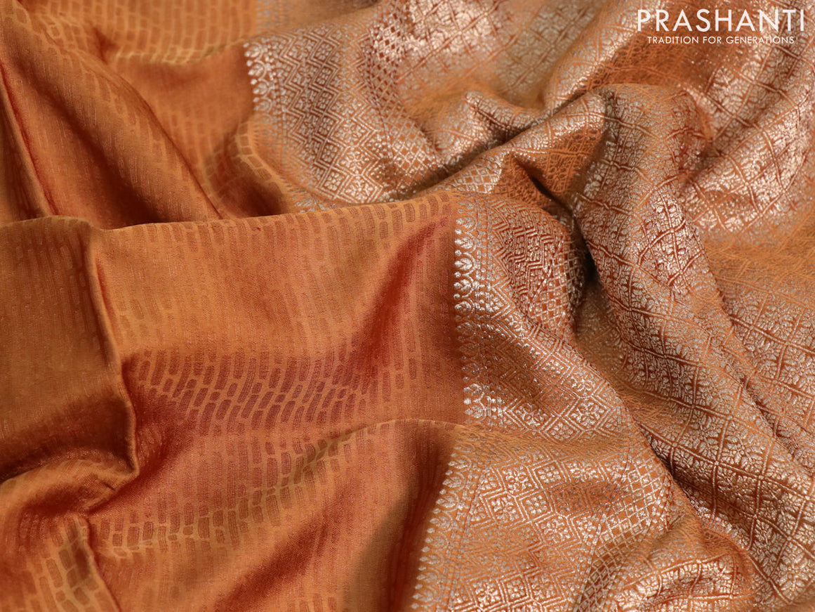 Mushru silk saree rust shade with allover self emboss and zari woven butta border