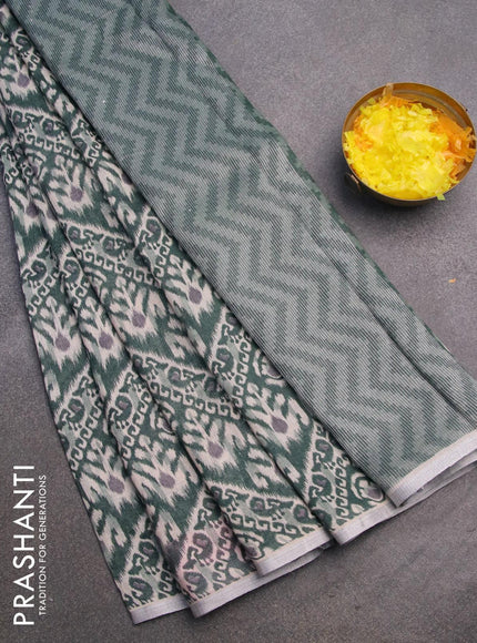 Pure linen saree sap green with allover ikat prints and silver zari woven piping border