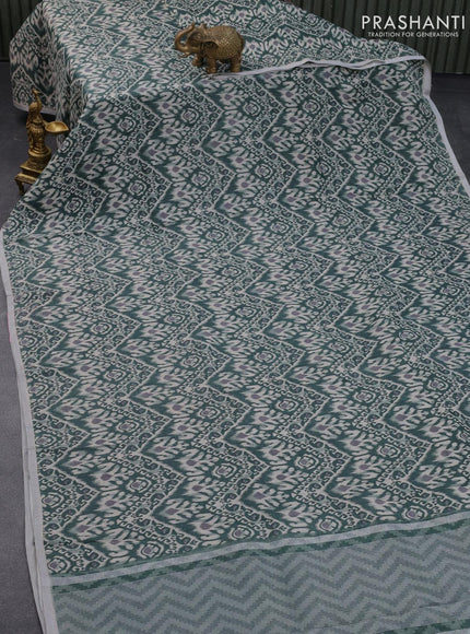 Pure linen saree sap green with allover ikat prints and silver zari woven piping border