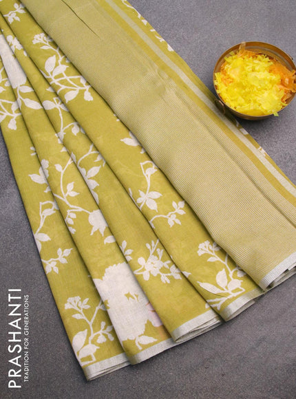 Pure linen saree lime green with allover floral prints and silver zari woven piping border