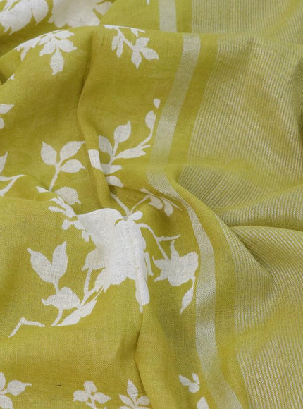 Pure linen saree lime green with allover floral prints and silver zari woven piping border