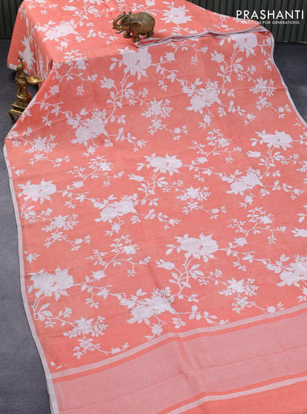 Pure linen saree peach orange with allover floral prints and silver zari woven piping border