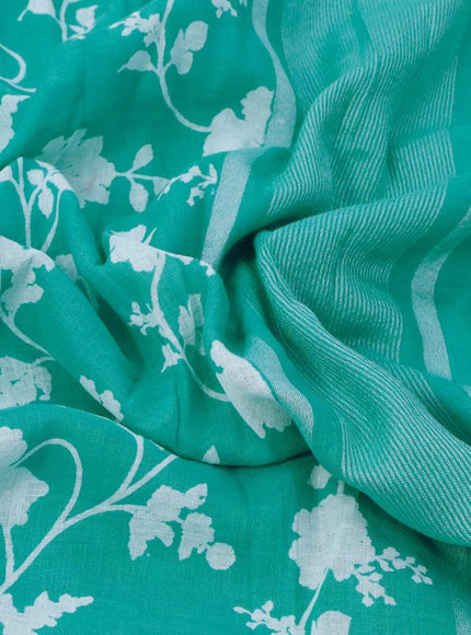 Pure linen saree teal blue with allover floral prints and silver zari woven piping border