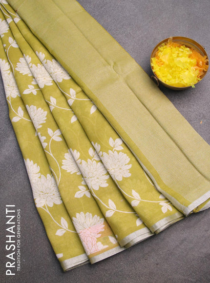 Pure linen saree lime green with allover floral prints and silver zari woven piping border