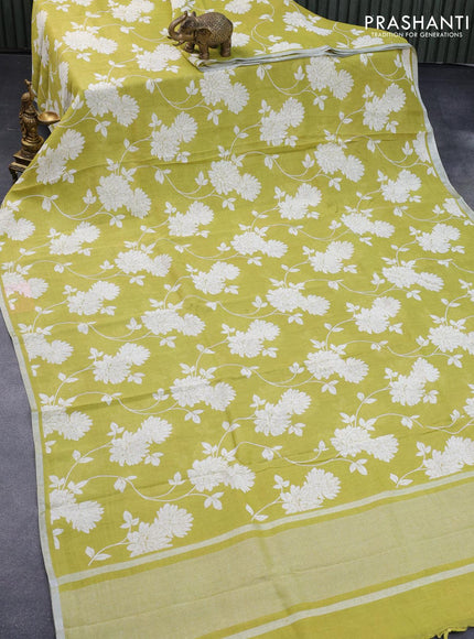 Pure linen saree lime green with allover floral prints and silver zari woven piping border