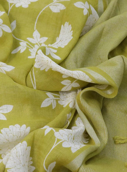 Pure linen saree lime green with allover floral prints and silver zari woven piping border