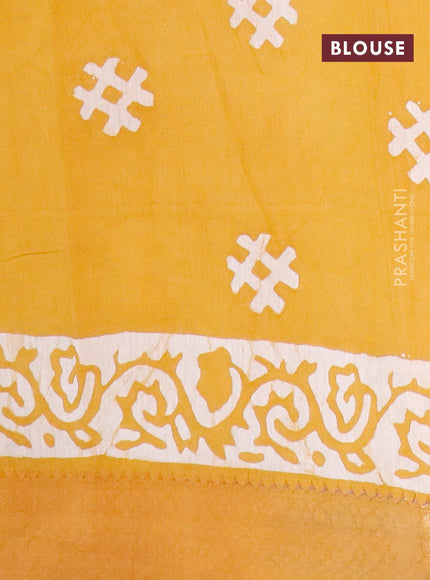 Semi gadwal saree dark mustard and off white with allover batik prints and zari woven border