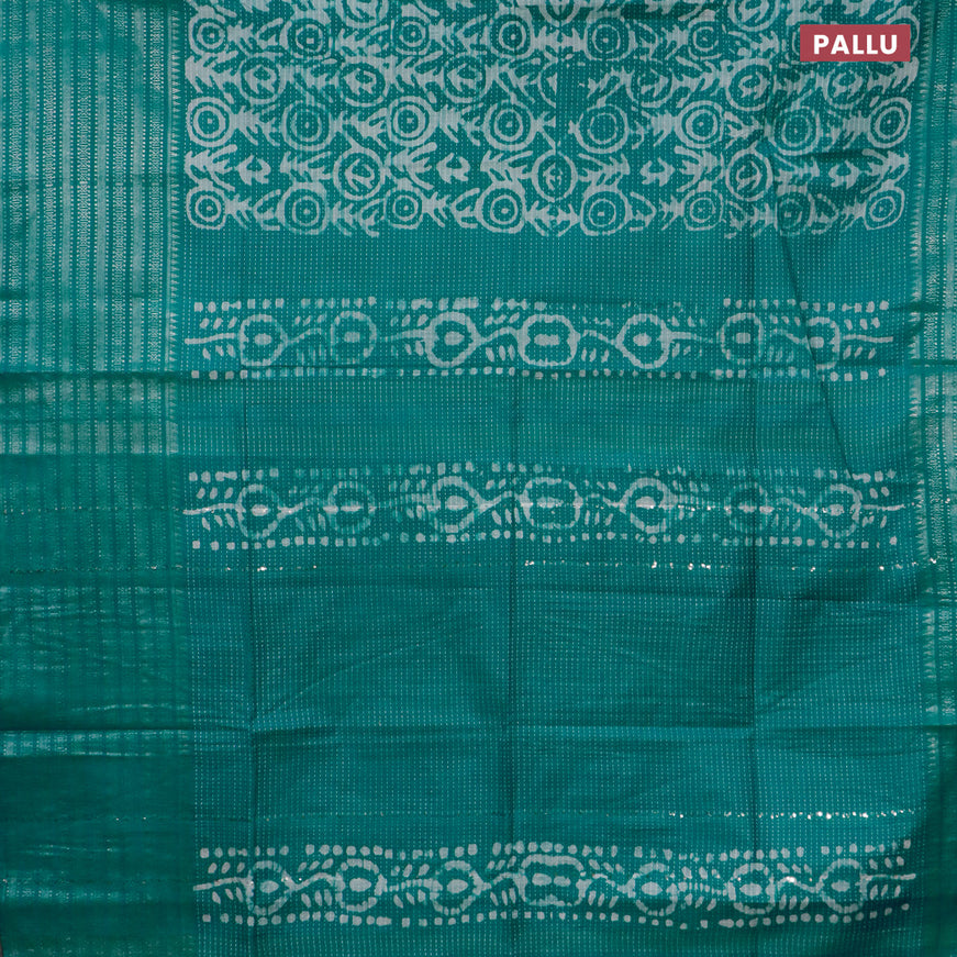 Semi tussar saree teal green with allover batik prints and long silver zari woven border