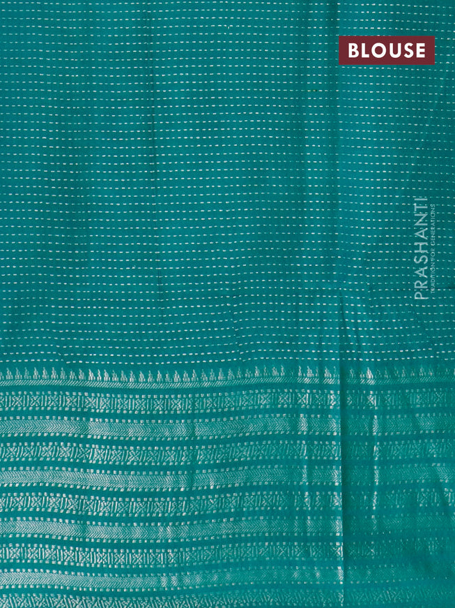 Semi tussar saree teal green with allover batik prints and long silver zari woven border