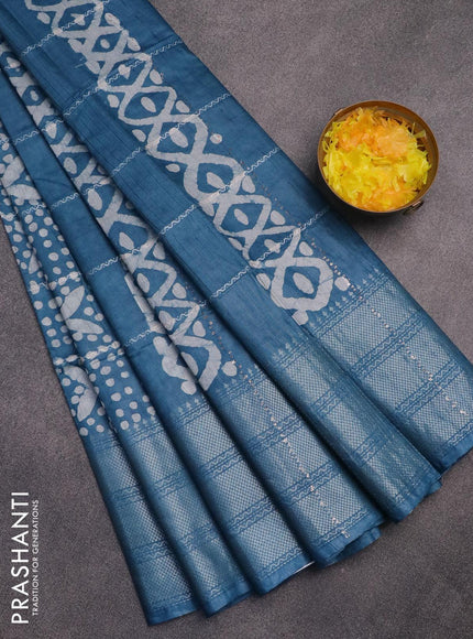 Semi tussar saree cs blue with allover batik prints and long silver zari woven border