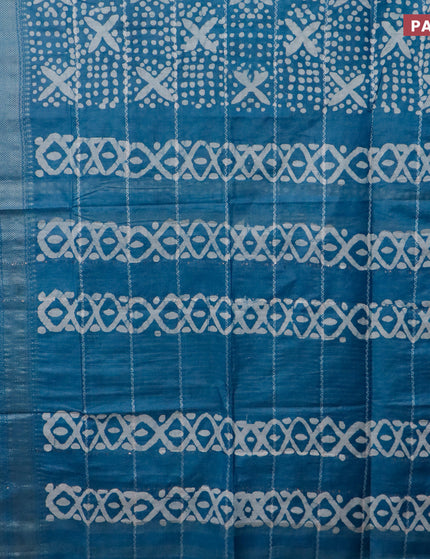 Semi tussar saree cs blue with allover batik prints and long silver zari woven border