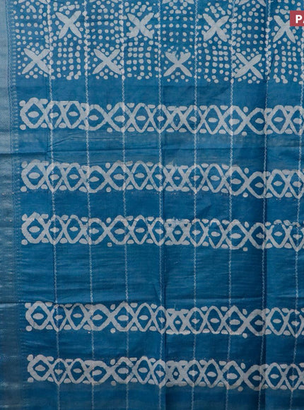 Semi tussar saree cs blue with allover batik prints and long silver zari woven border