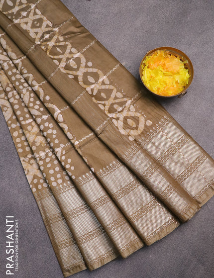 Semi tussar saree mehendi green with allover batik prints and long silver zari woven border