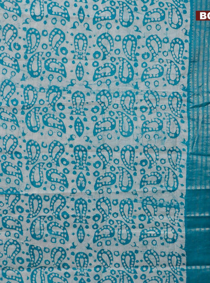 Semi tussar saree teal blue and beige with allover batik prints and long zari woven border