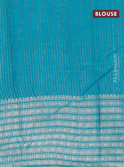 Semi tussar saree teal blue and beige with allover batik prints and long zari woven border