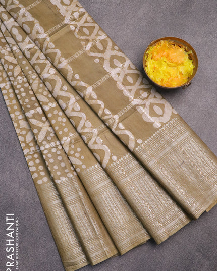 Semi tussar saree elaichi green with allover batik prints and long zari woven border