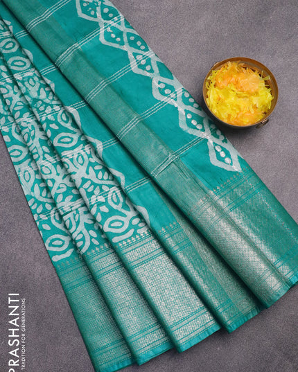 Semi tussar saree teal green and off white with allover batik prints and long zari woven border