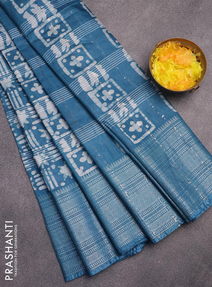 Semi tussar saree peacock blue and off white with allover batik prints and long silver zari woven border