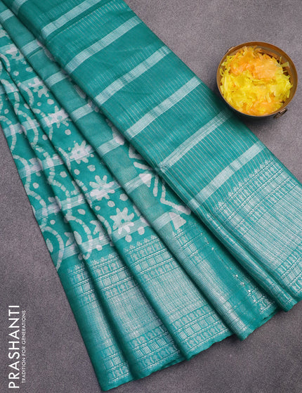 Semi tussar saree teal green with allover batik prints and long silver zari woven border