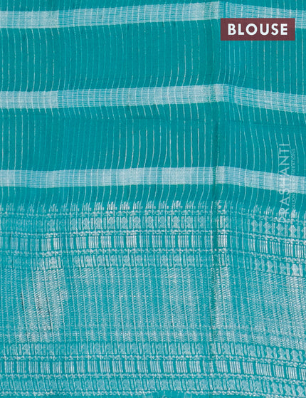 Semi tussar saree teal green with allover batik prints and long silver zari woven border