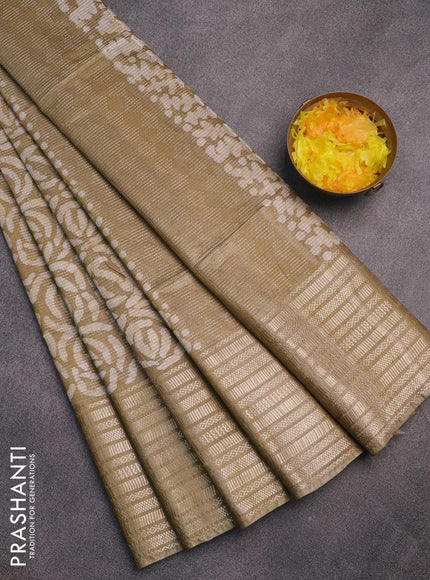 Semi tussar saree elaichi green and beige with allover batik prints and long silver zari woven border