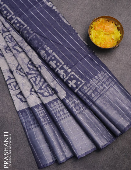 Semi tussar saree off white and dark grey with allover batik prints and long zari woven border