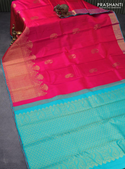 Pure kanjivaram silk saree dual shade of pinkish orange and teal blue with paisley zari woven buttas and long zari woven border & butta style