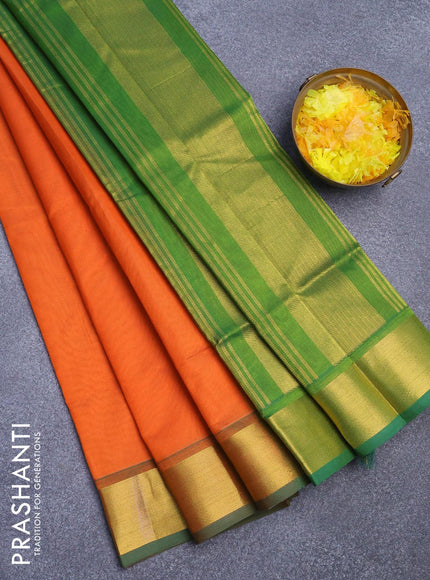 Silk cotton saree orange and green with plain body and zari woven border