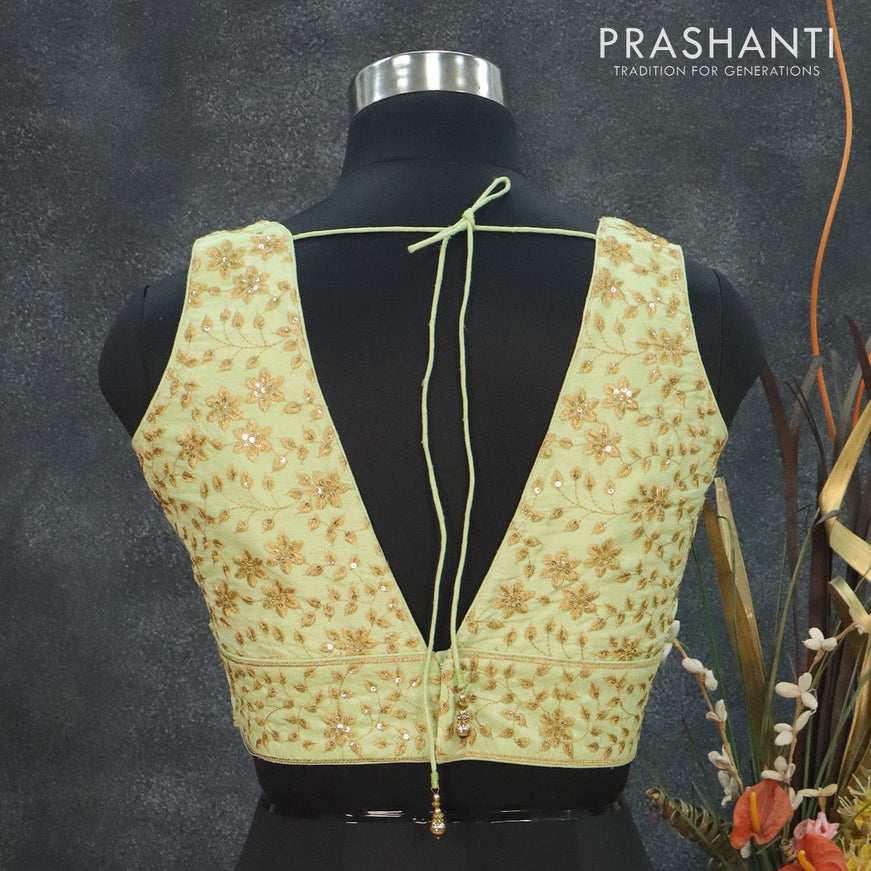 Readymade raw silk sleeveless blouse pista green and arri work with V shape neck pattern and back open