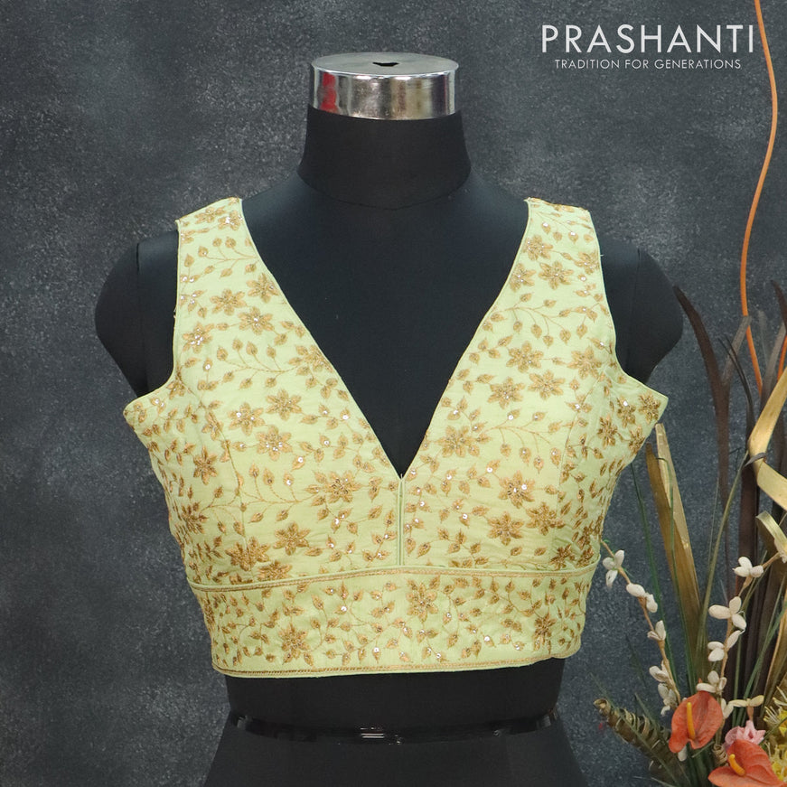 Readymade raw silk sleeveless blouse pista green and arri work with V shape neck pattern and back open